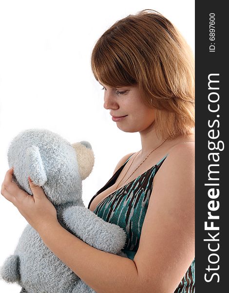 The young girl holds a teddy bear.