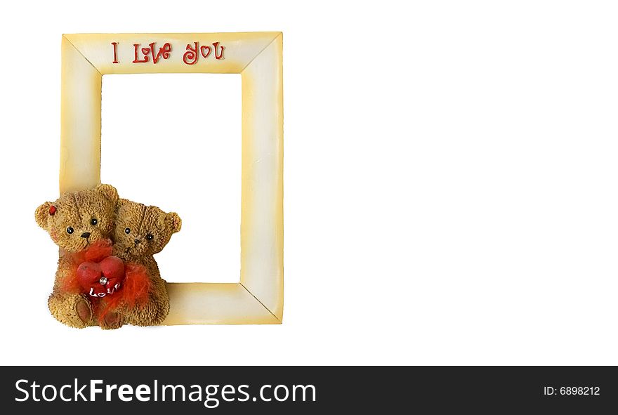 Two teddy bears with one heart sitting on the frame. Two teddy bears with one heart sitting on the frame