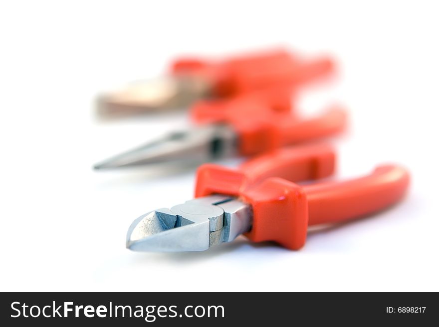 Pliers with red handles on white background