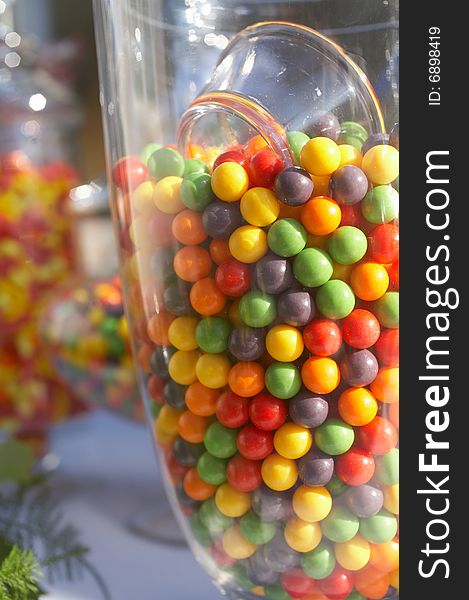 Closeup of glass of colorful candy gumballs