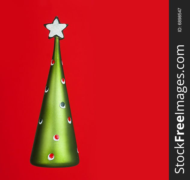 Abstract Christmas tree with star on red back ground with copy space