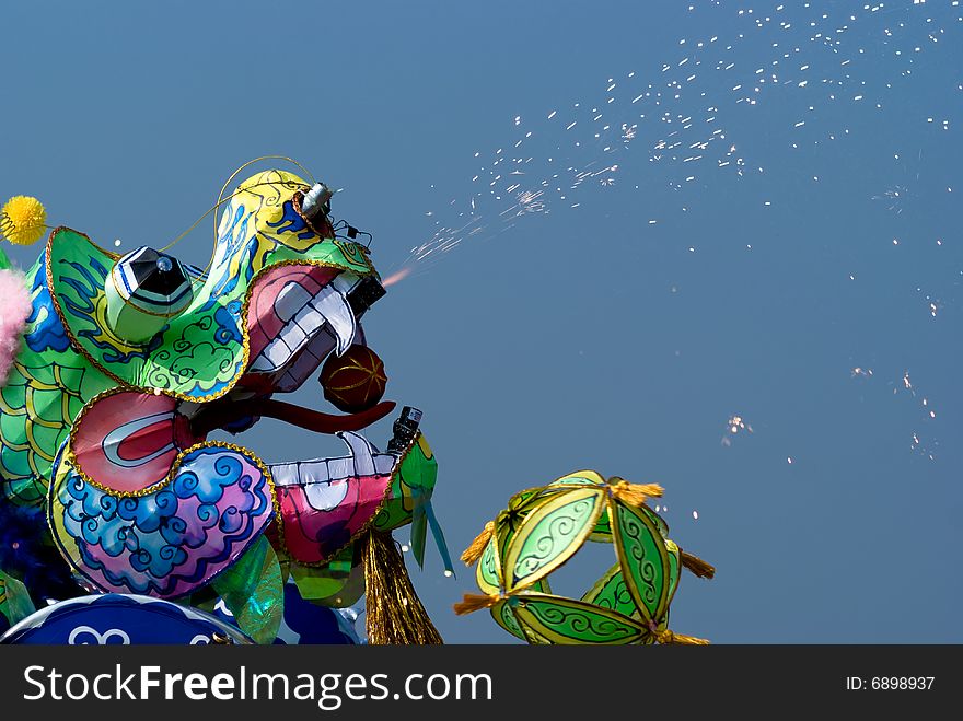 A chinese paper dragon giving fireworks. A chinese paper dragon giving fireworks