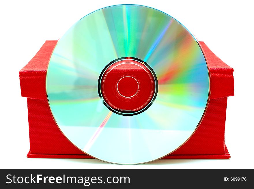 Compact-disk (CD or DVD) and red cardboard box on isolated background. Compact-disk (CD or DVD) and red cardboard box on isolated background.