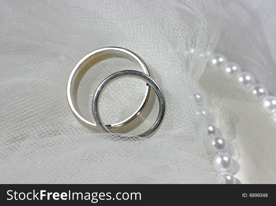 Wedding bands on a white veil. Wedding bands on a white veil
