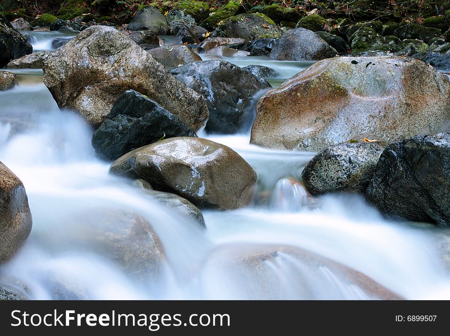 A rushing river tumbles through boulders in Squamish, BC. A rushing river tumbles through boulders in Squamish, BC.