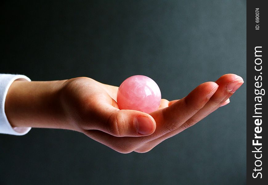 Hand and pink stone sphere. Hand and pink stone sphere