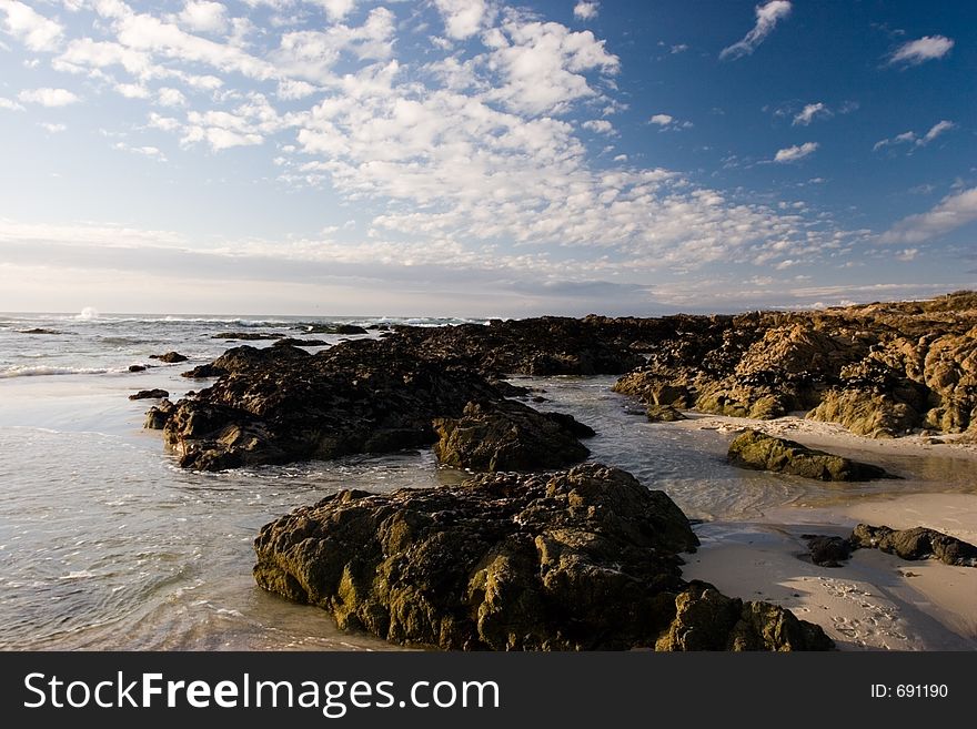 Rocks and tide pools on a sunny beach