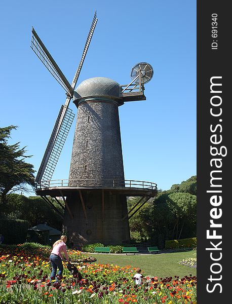 Windmill, flowers, mother and child.