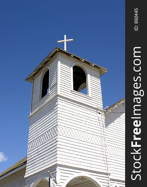 Older fixed up church beel tower with cross. Older fixed up church beel tower with cross