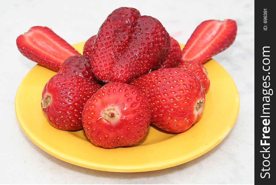 Strawberries on a yellow plate