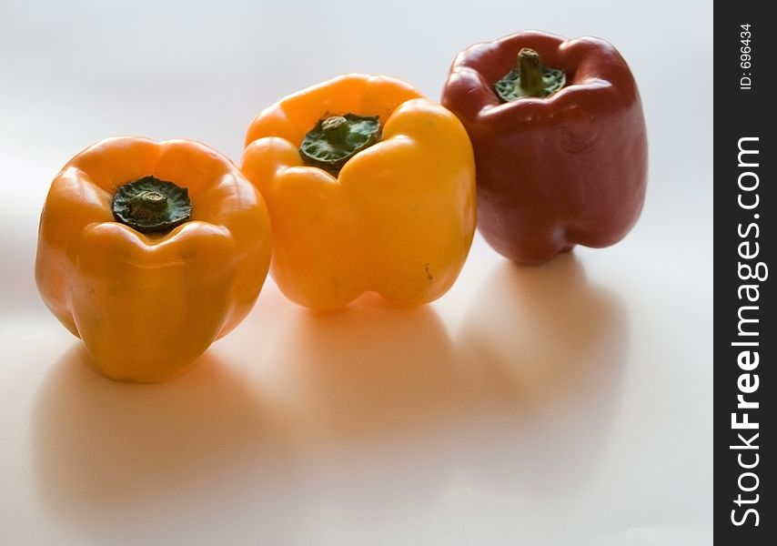 Red and yellow peppers on white background