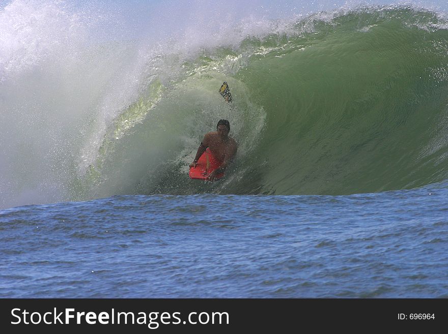 Bodyboarder Surfing A Tube