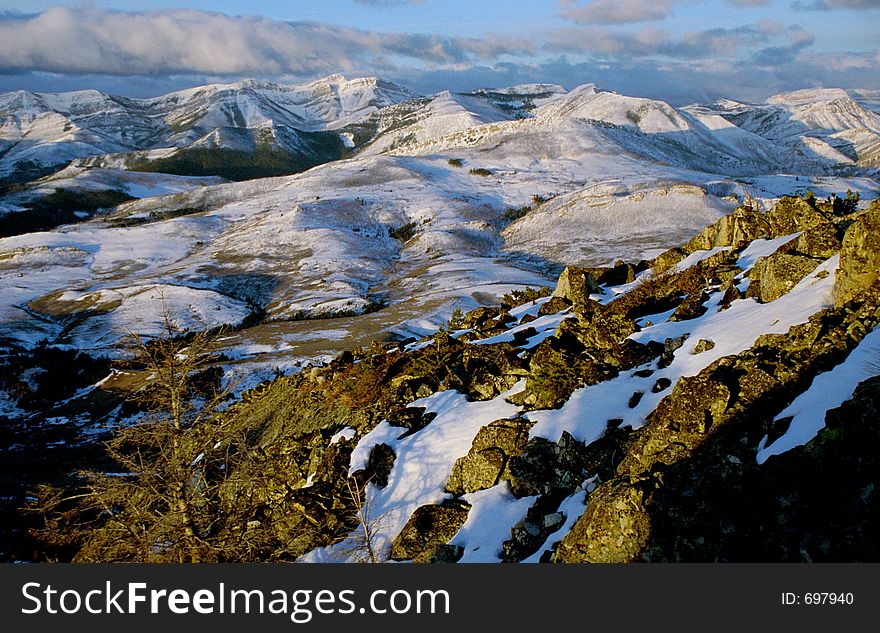 Sunrise over the Montana Rockies from the peak of a mountain. Sunrise over the Montana Rockies from the peak of a mountain.