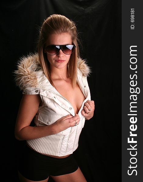 model wearing winter coat and shades. model wearing winter coat and shades