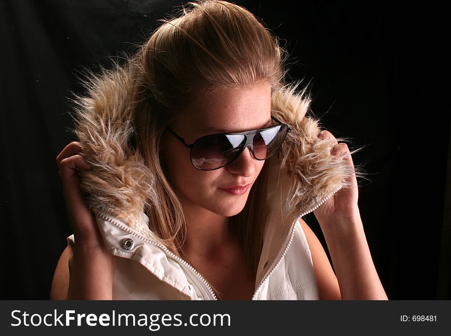 Model wearing a ski jacket and shades. Model wearing a ski jacket and shades