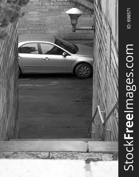 Car is waiting down by stairs. Car is waiting down by stairs