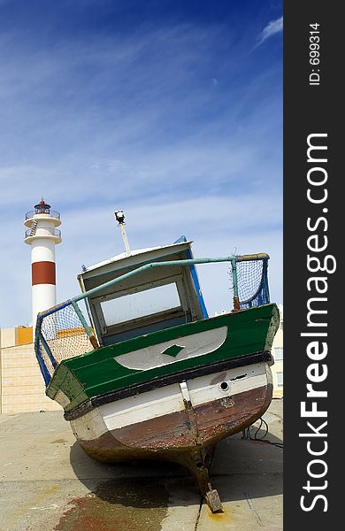 Boat and lighthouse in a spanish town