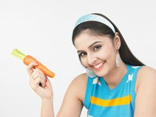Asian Female With A Carrot Royalty Free Stock Photography