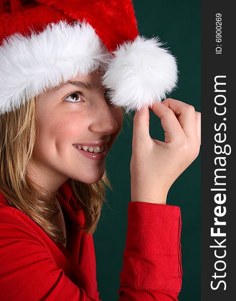 Beautiful teenager wearing a red shirt and christmas hat. Beautiful teenager wearing a red shirt and christmas hat
