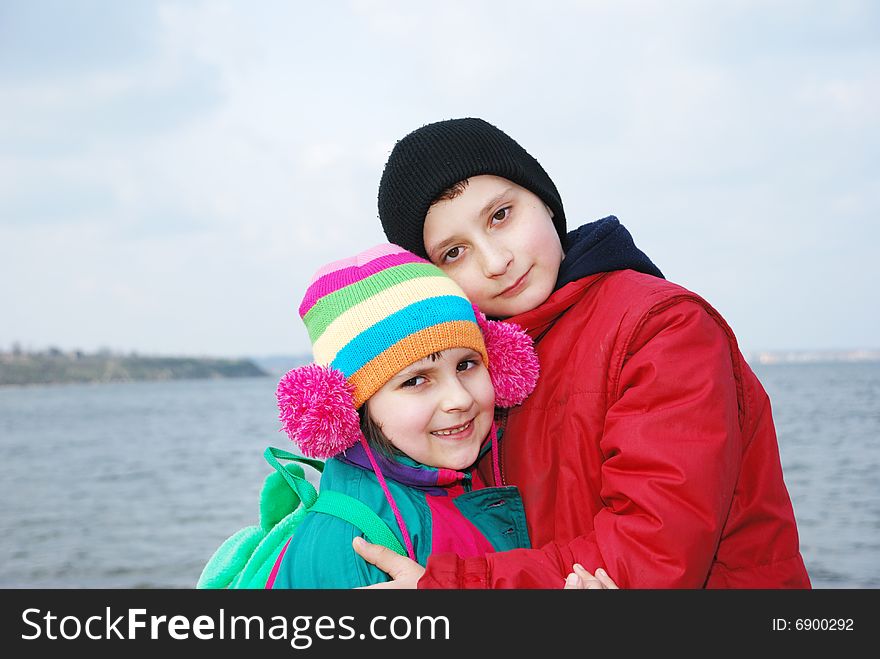 Happy brother and sister over nature background. Happy brother and sister over nature background