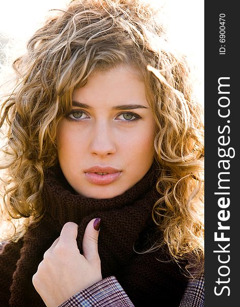 Closeup portrait of young blond woman outdoors