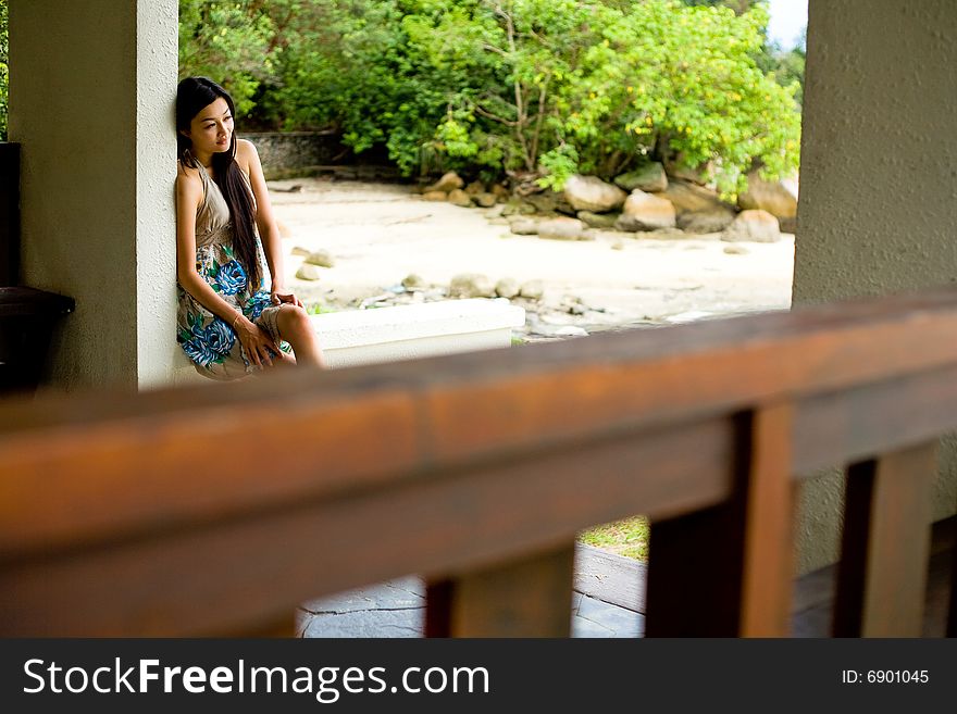 Woman relaxing under the hut