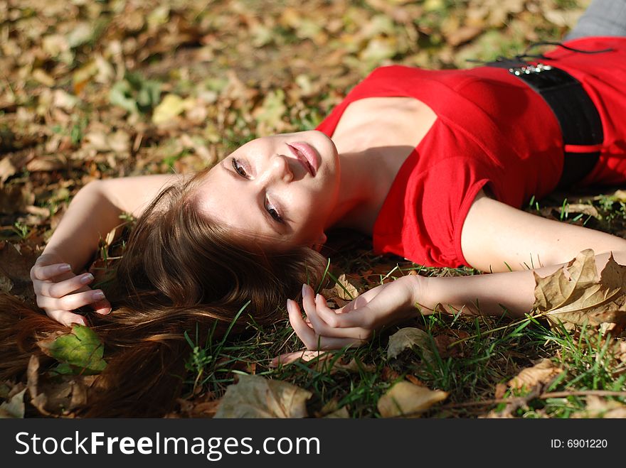 Beautiful young woman lying on the maple leaf. Beautiful young woman lying on the maple leaf