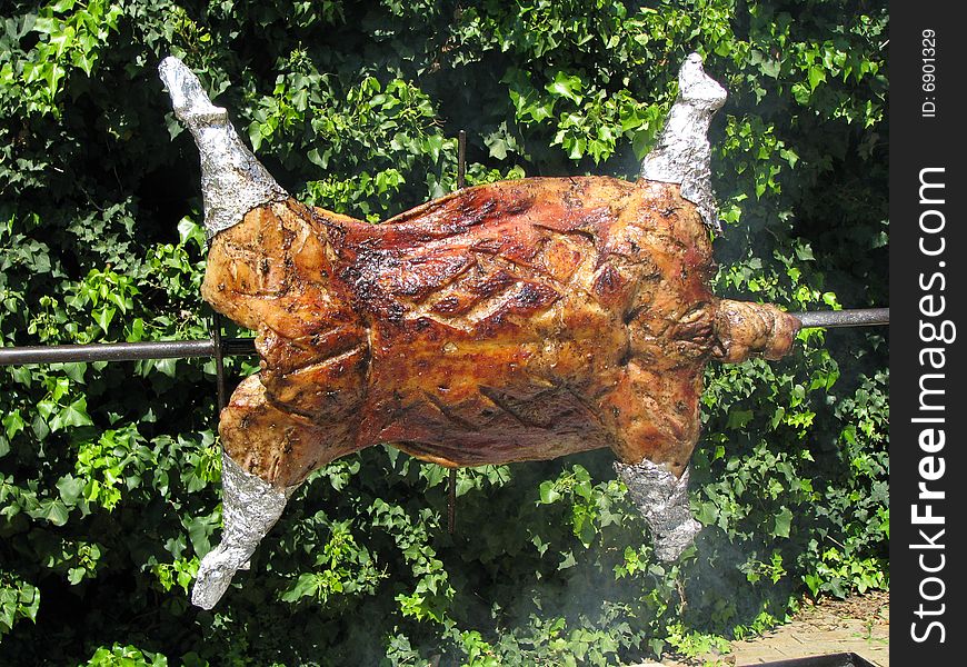 Lamb on a spit being cooked.