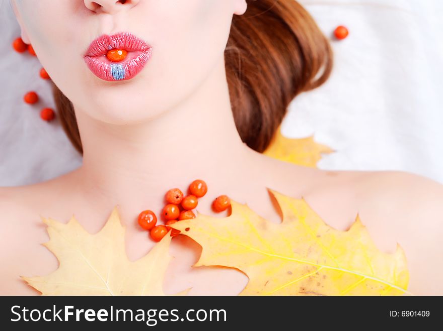 Portrait of a young woman with ashberry in her lips. Portrait of a young woman with ashberry in her lips