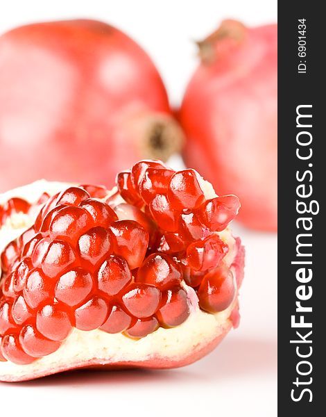 Fresh appetizing pomegranate on a white background. Fresh appetizing pomegranate on a white background