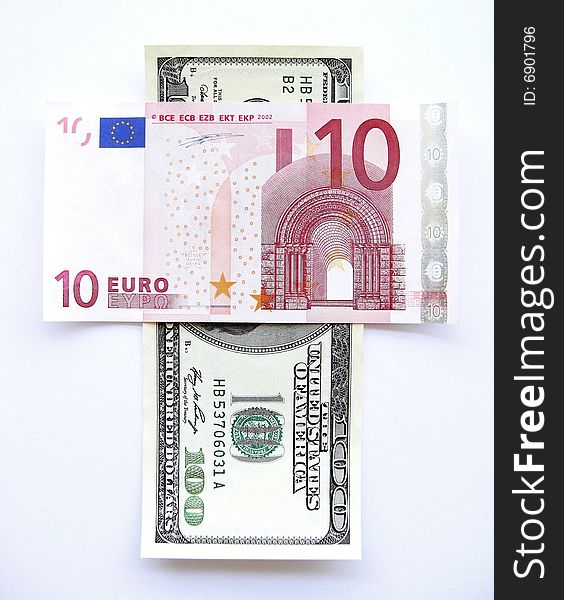 100 dollar and 10 euro in a shape of a cross. 100 dollar and 10 euro in a shape of a cross