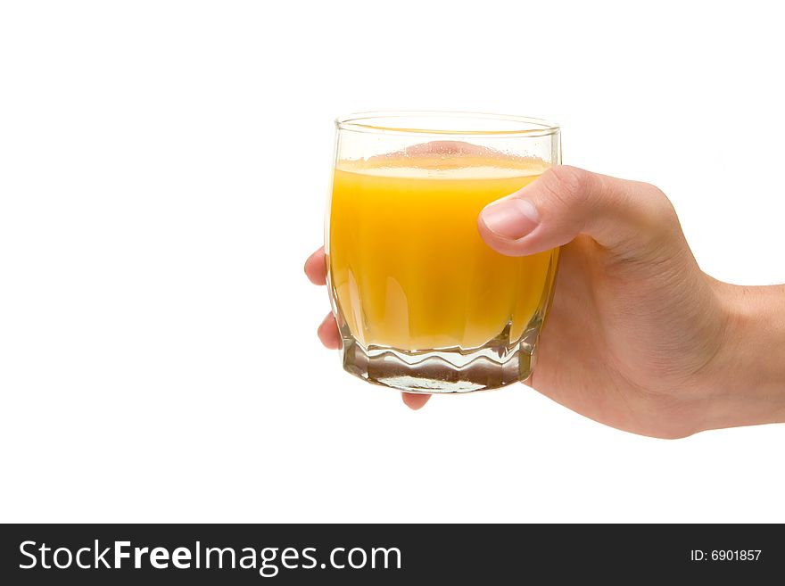 Glass of orange juice in hand on white