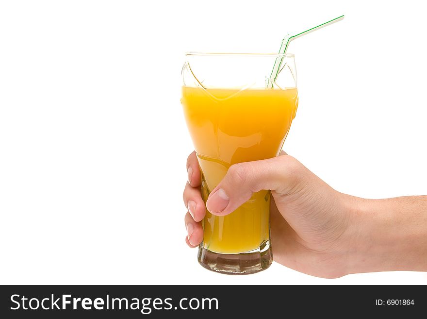 Hand holding glass of orange juice on white