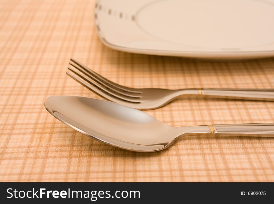 Plate with fork and spoon on table