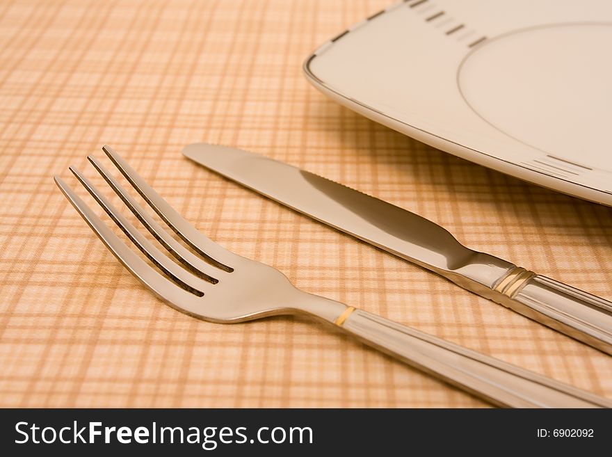 Plate with fork and knife on table