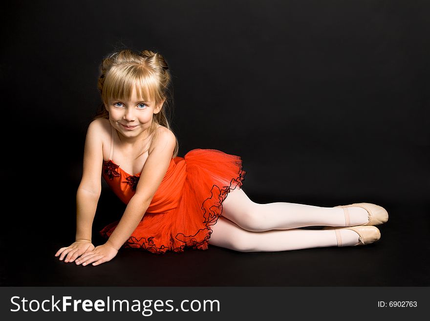 Young ballet dancer wearing a bright red tutu. Young ballet dancer wearing a bright red tutu