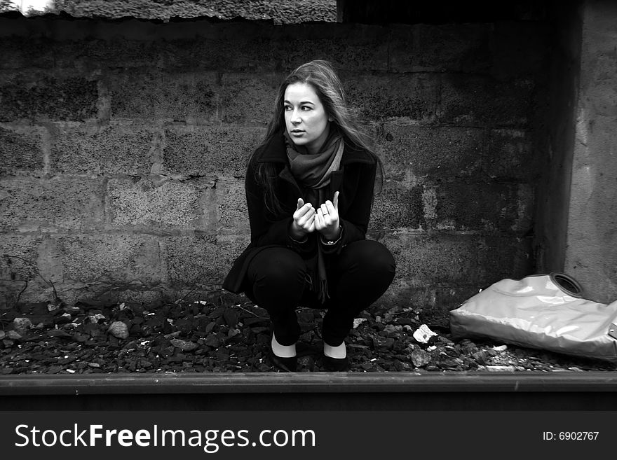 A girl squating under the platform