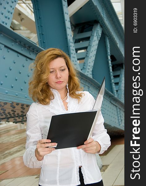 Business woman reading document in the folder