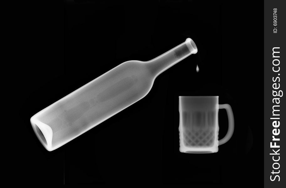 X-ray picture :drip in mug from a bottle on black background