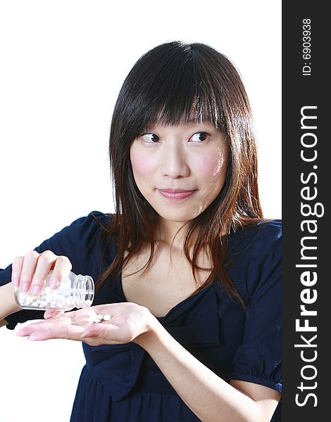 Asian girl pour pills on the hand. Asian girl pour pills on the hand
