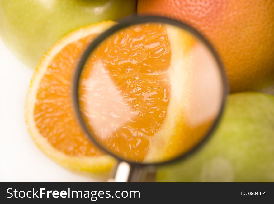 A few of citrus fruits with the orange under the lens. A few of citrus fruits with the orange under the lens