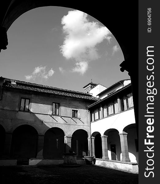 A suggestivemonochrome of an ancient cloister in Florence countryside