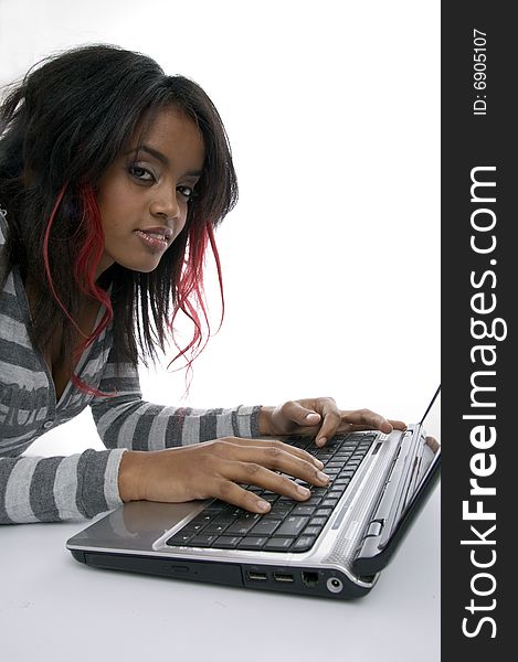 Girl working on laptop against white background