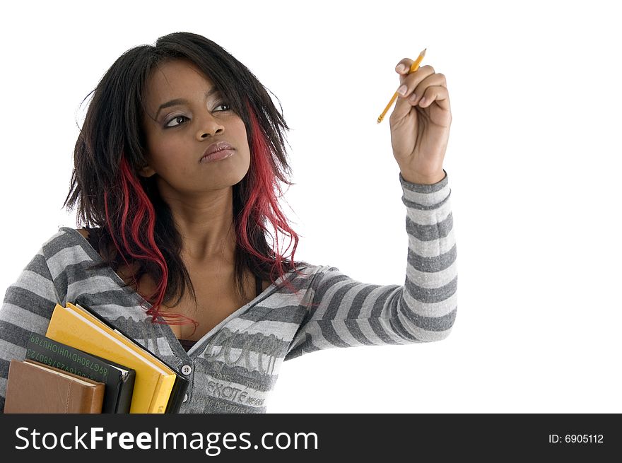 Girl with books and looking to pencil against white background