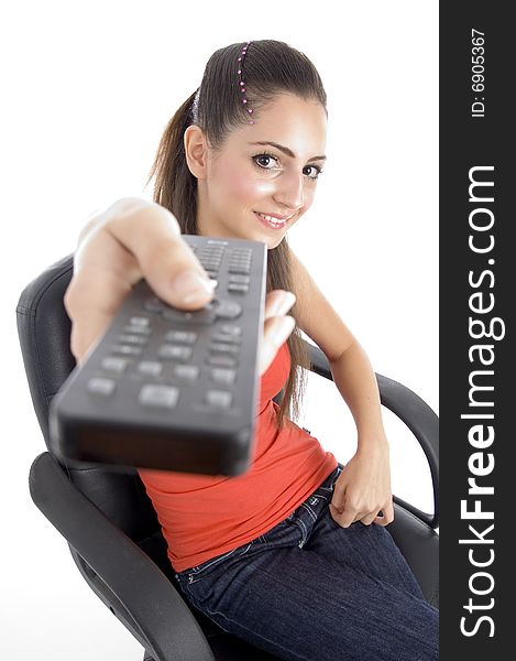 Sitting girl showing remote on an isolated white background