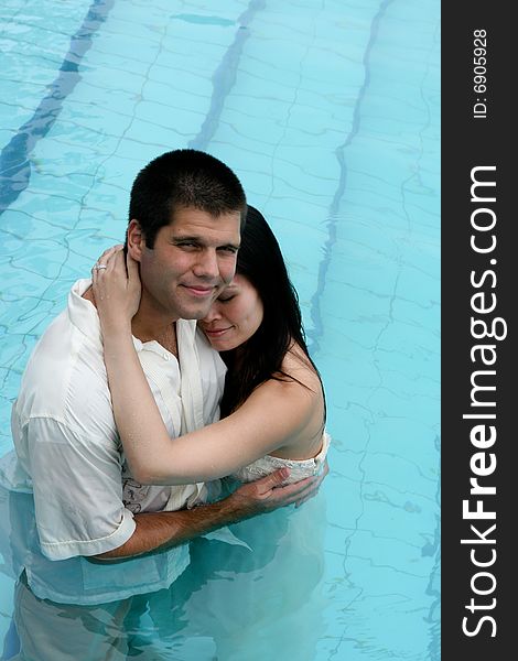 Bride and groom in the swimming pool - trash the dress trend. Bride and groom in the swimming pool - trash the dress trend.