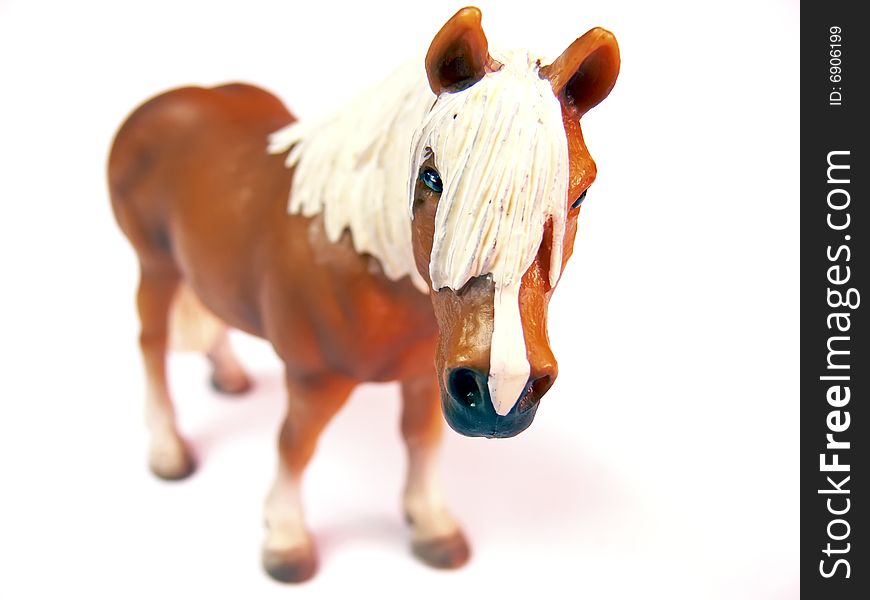 Close up of the plastic toy horse isolated on white background. Close up of the plastic toy horse isolated on white background.