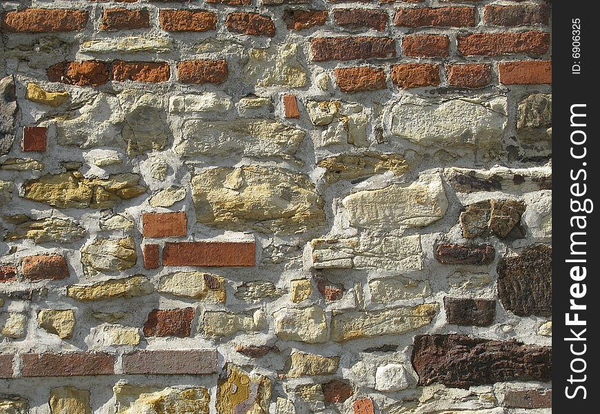 Wall made of briks and stones background. Wall made of briks and stones background
