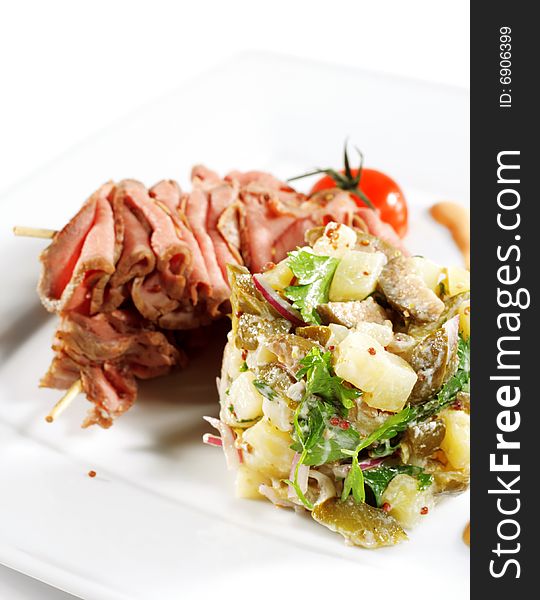 Roast Beef Served with Salad (Potatoes and Vegetables) and Cherry Tomato. Isolated on White Background