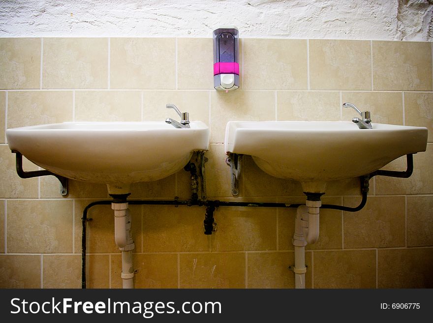 Two sinks in an empty public toilet. Two sinks in an empty public toilet